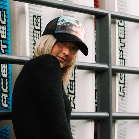 a women using a SHÜE GRAPHIC mesh TRUCKER CAPS for women